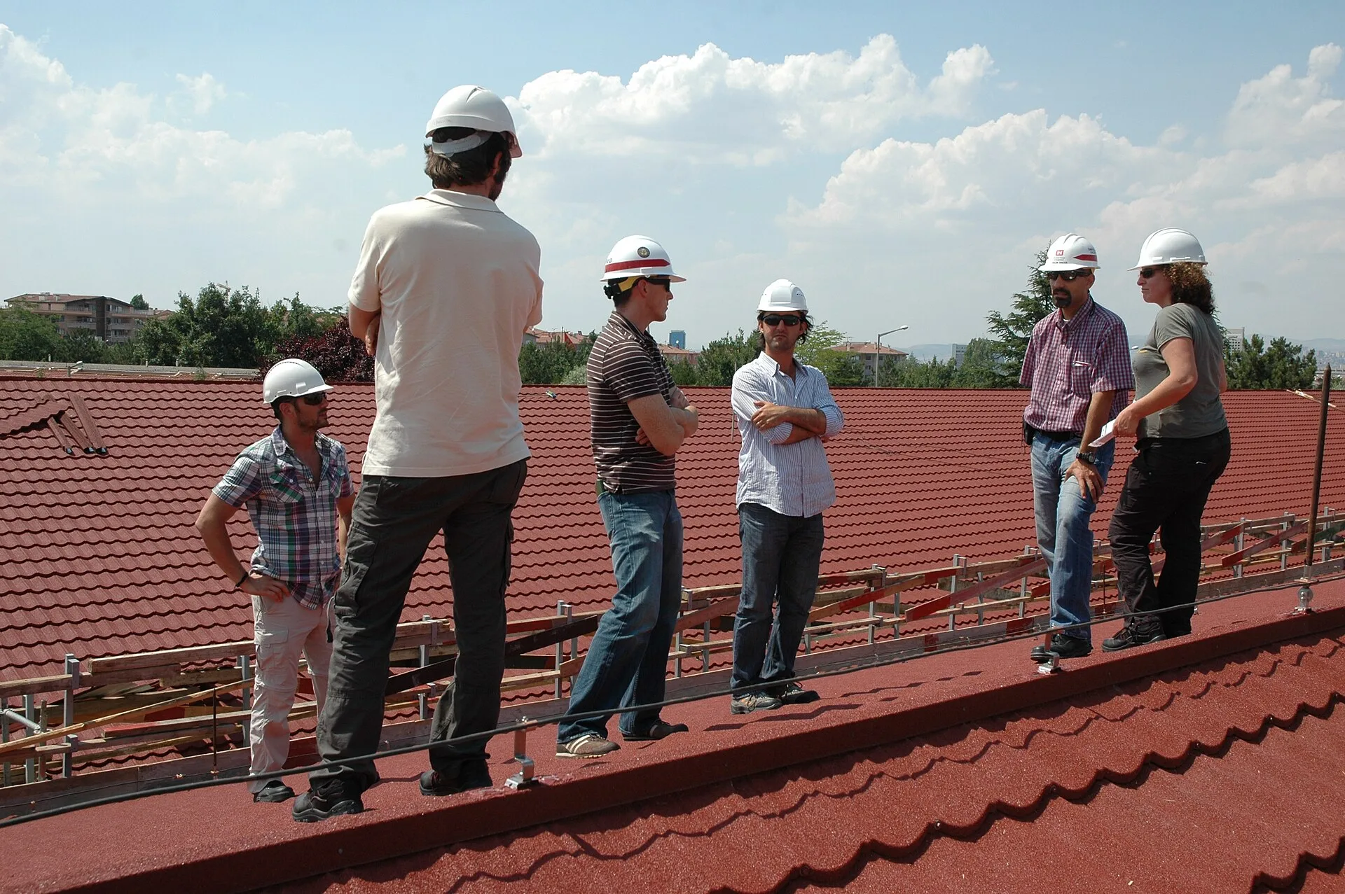 Capt. Josh Sturgill (third from left), Turkey Resident Office deputy resident engineer, Orkun Dincer (second from right), acting resident engineer, both with the U.S. Army Corps of Engineers Europe District, and representatives with the contractor conduct a progress inspection July 7, 2011, of the r. Roofing contractor complaint handling compared with what actually happens