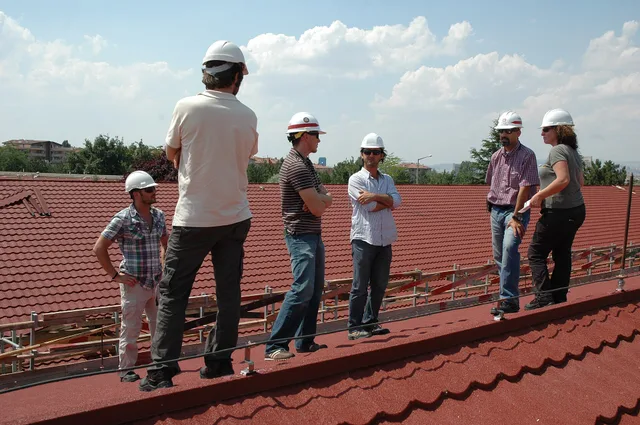 Capt. Josh Sturgill (third from left), Turkey Resident Office deputy resident engineer, Orkun Dincer (second from right), acting resident engineer, both with the U.S. Army Corps of Engineers Europe District, and representatives with the contractor conduct a progress inspection July 7, 2011, of the r. Roofing contractor complaint handling compared with what actually happens