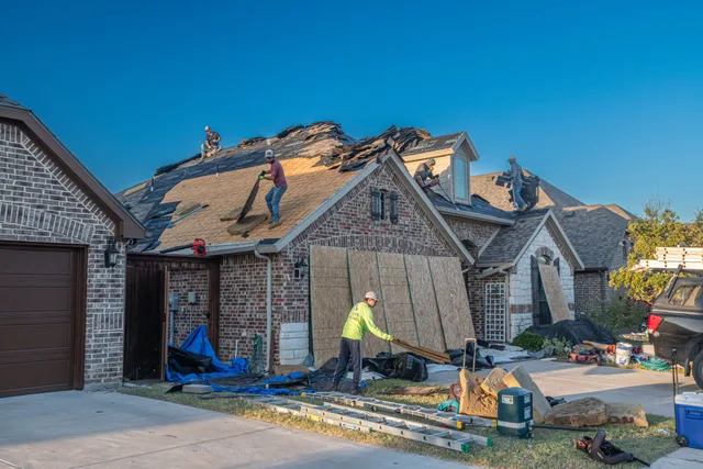 Workers engage in roof replacement on a brick house in Fort Worth, Texas. Funding a new roofing contractor business: costs first, then the options